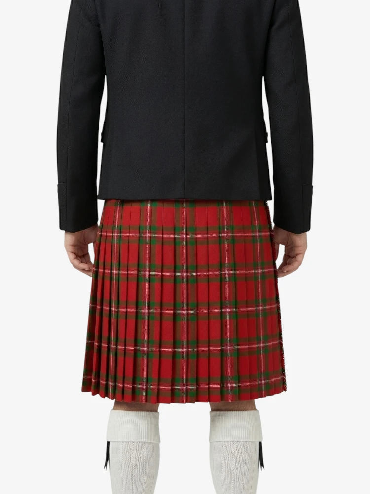 Person wearing a black jacket and red plaid skirt on a white background