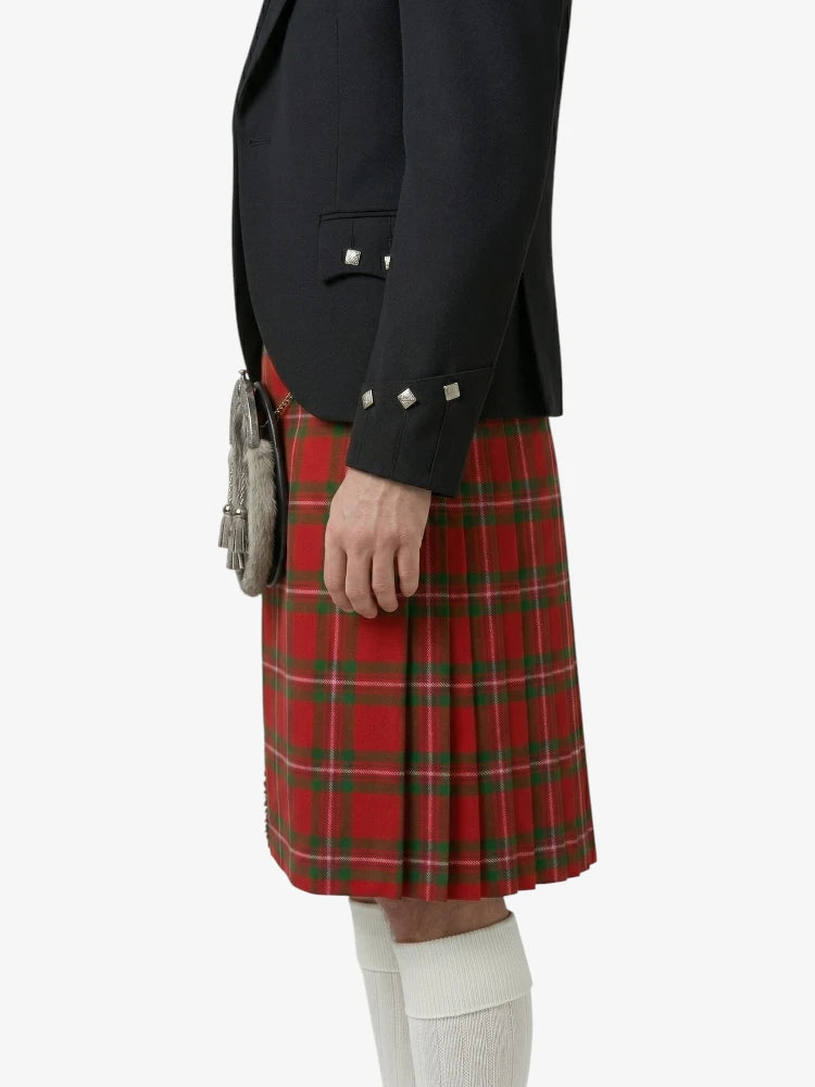 Person wearing a black jacket and red plaid kilt on a white background
