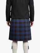 Person wearing a black coat and blue plaid kilt on a white background