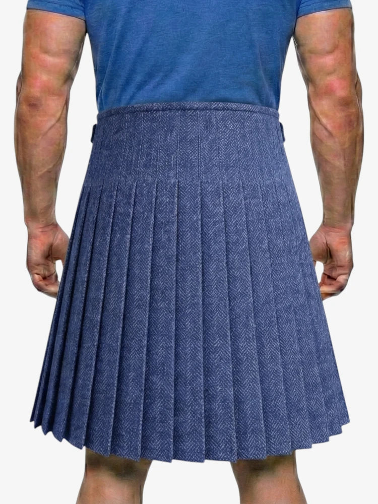 Person wearing a blue pleated skirt on a white background