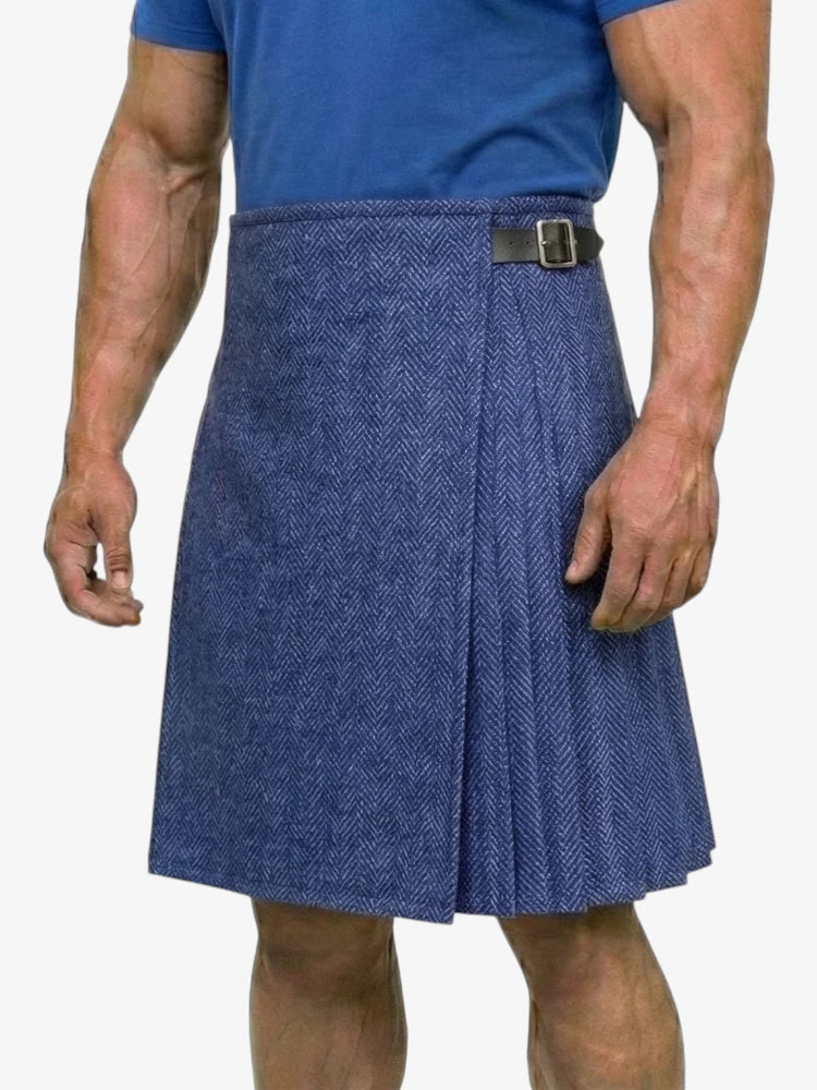 Person wearing a blue herringbone kilt on a white background
