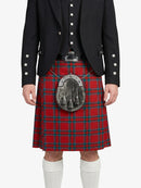 Person wearing a red tartan kilt with a black jacket on a white background