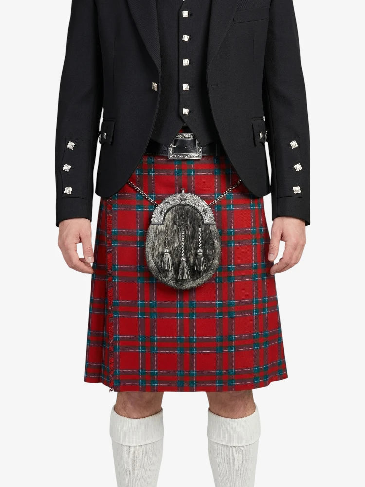 Person wearing a red tartan kilt with a black jacket on a white background