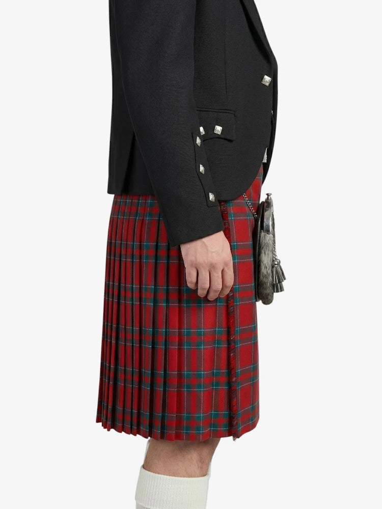 Person wearing a black blazer and red plaid kilt on a white background