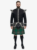 Man wearing a black doublet jacket with white accents and a irish national plaid kilt on a white background