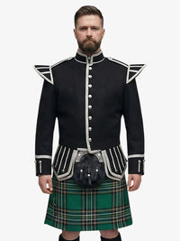 Man wearing a black doublet jacket with white trim and a irish national plaid tartan kilt on a white background