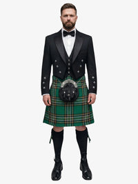 Man wearing a traditional Scottish irish national tartan kilt with a black prince charlie jacket on a white background