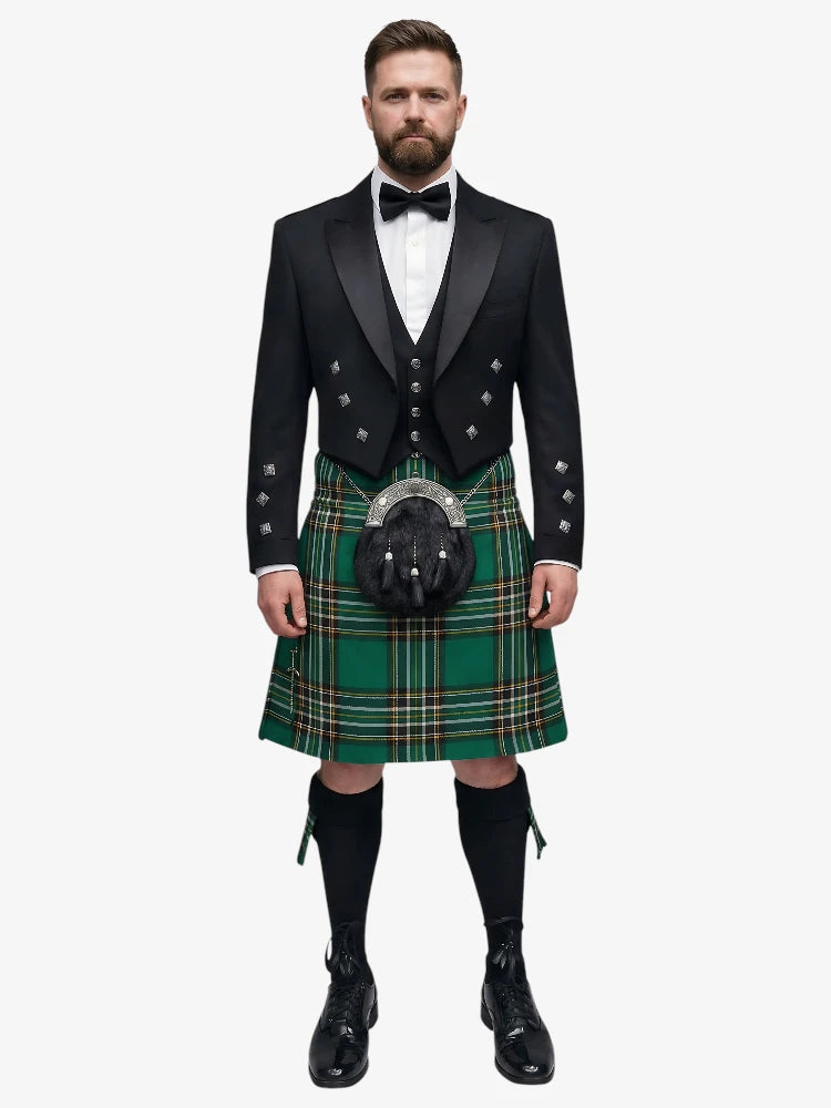 Man wearing a traditional Scottish irish national tartan kilt with a black prince charlie jacket on a white background