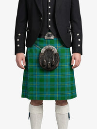 Person wearing a green tartan kilt with a black jacket on a white background