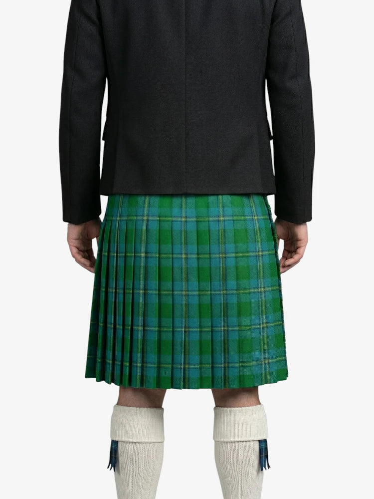 Person wearing a green plaid kilt with a black jacket on a white background