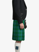 Person wearing a green plaid kilt with a black jacket on a white background