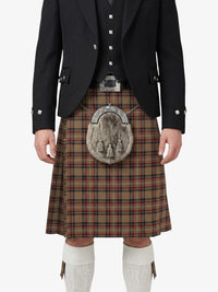 Person wearing a traditional Scottish kilt with a jacket on a white background