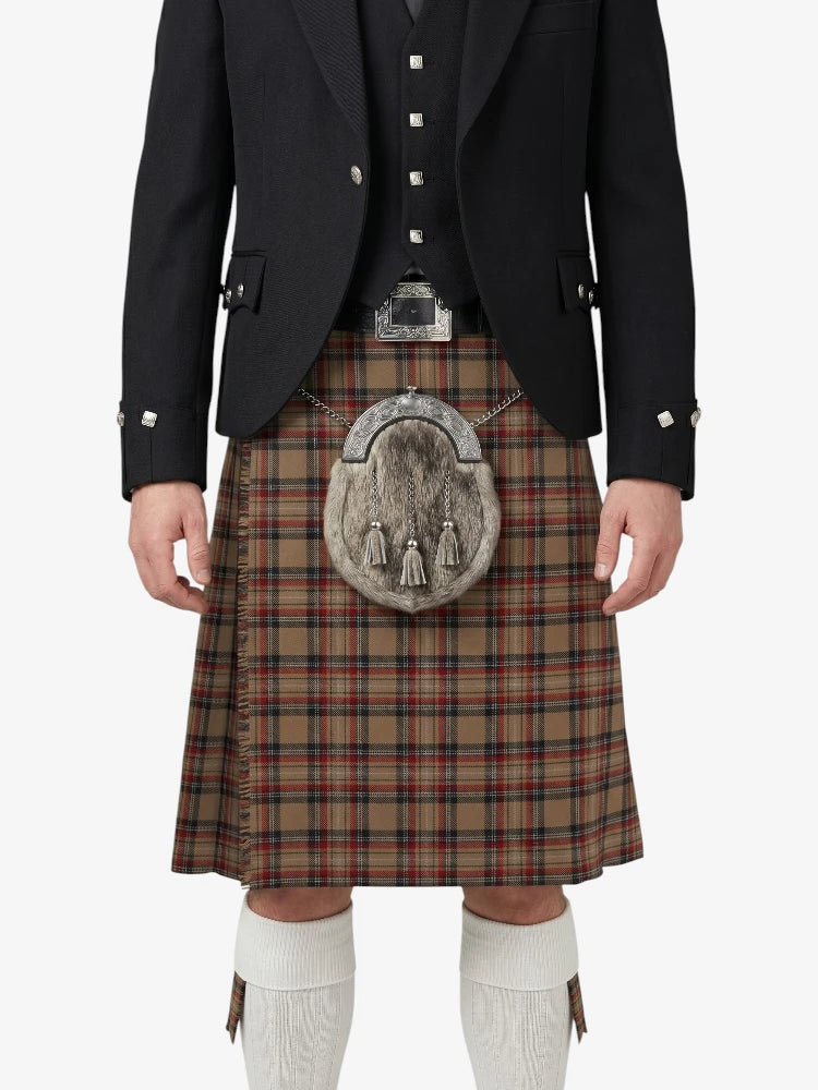 Person wearing a traditional Scottish kilt with a jacket on a white background