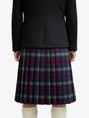 Person wearing a black coat and plaid kilt on a white background