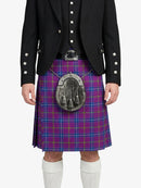 Person wearing a Scottish kilt with a patterned pouch on a white background