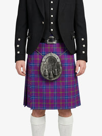 Person wearing a Scottish kilt with a patterned pouch on a white background