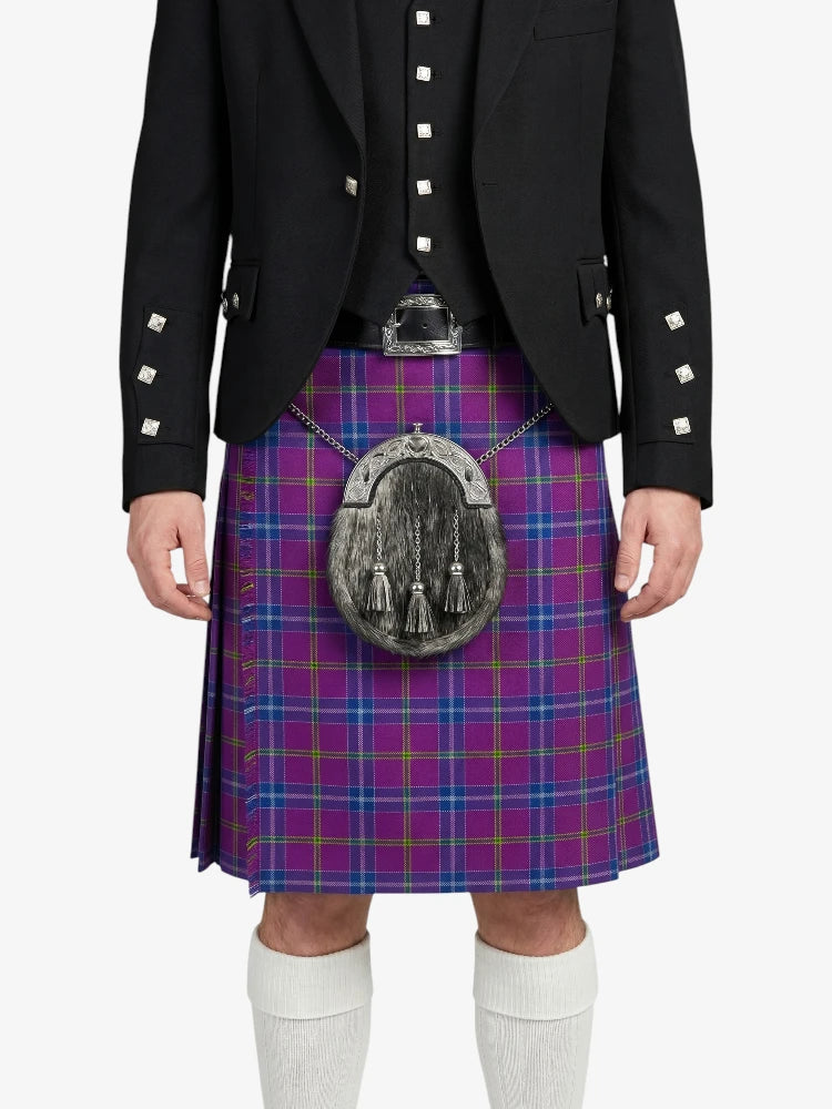 Person wearing a Scottish kilt with a patterned pouch on a white background
