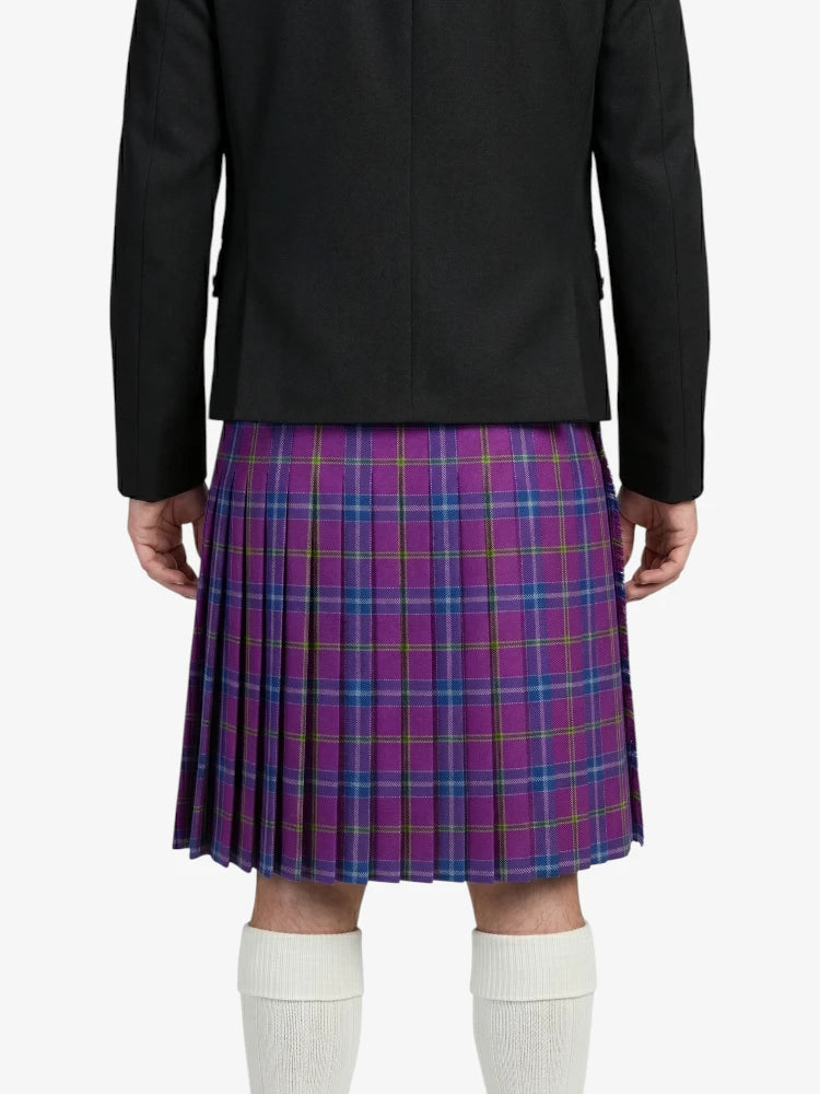 Person wearing a black jacket and purple plaid kilt on a white background