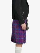 Person wearing a black jacket and purple plaid kilt on a white background