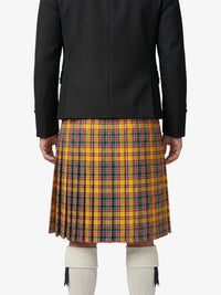 Person wearing a black coat and yellow plaid kilt on a white background