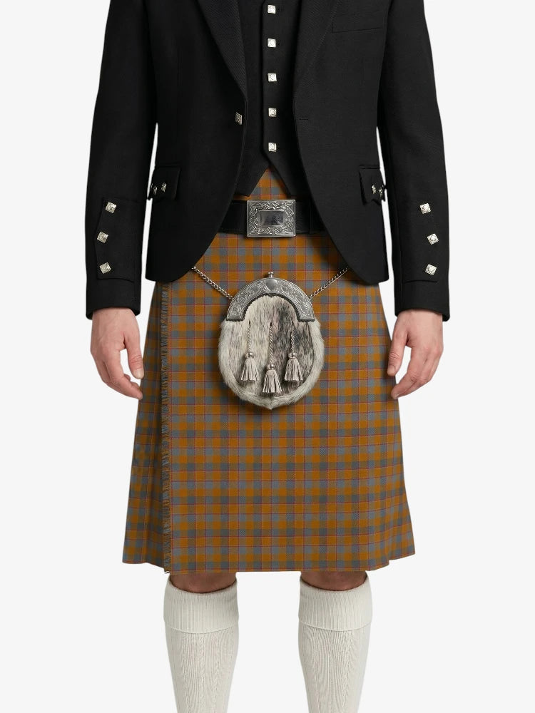 Person wearing a traditional Scottish kilt with a jacket on a white background