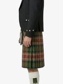 Person wearing a black jacket and plaid kilt on a white background