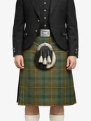 Person wearing a green plaid kilt with a black jacket on a white background