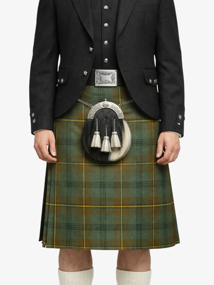 Person wearing a green plaid kilt with a black jacket on a white background