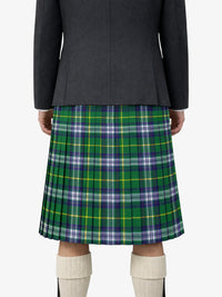 Person wearing a black and green plaid skirt on a white background