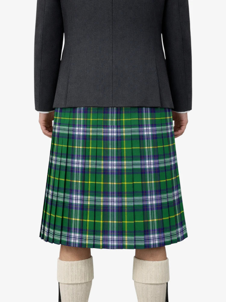 Person wearing a black and green plaid skirt on a white background