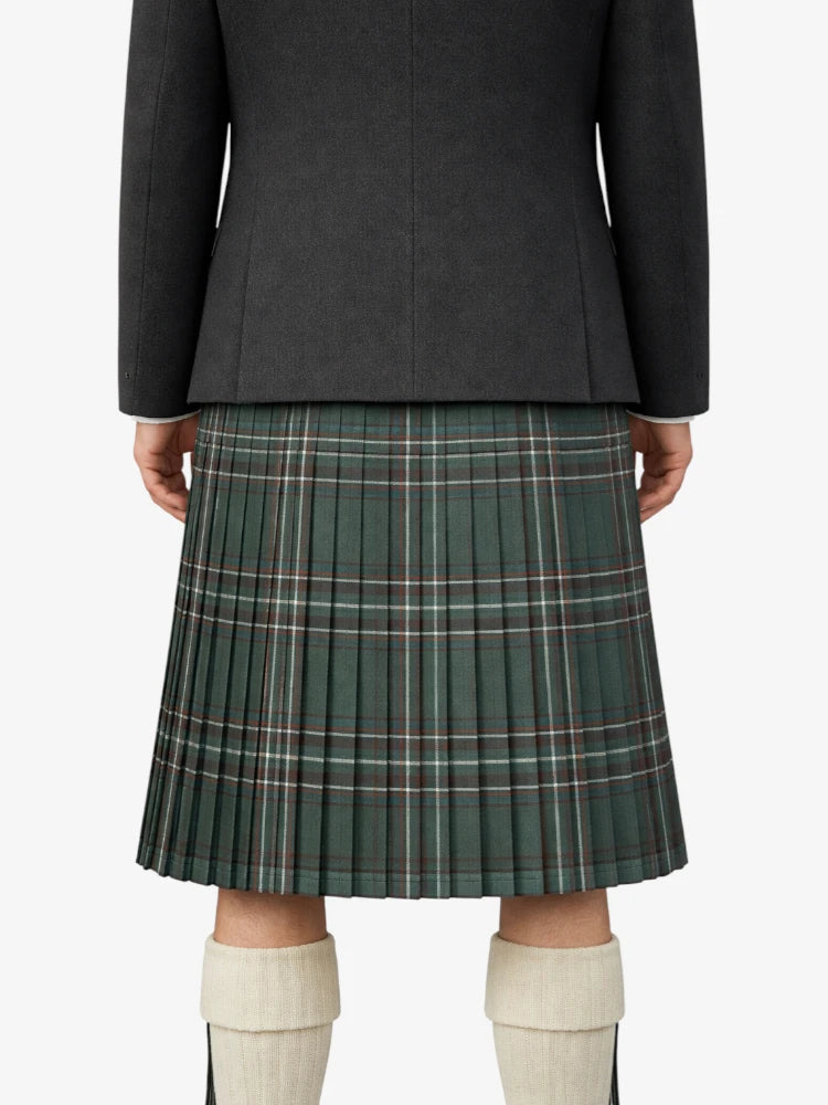 Person wearing a dark gray jacket and green plaid kilt on a white background