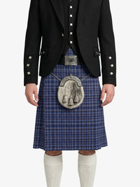 Person wearing a traditional Scottish kilt with a jacket on a white background