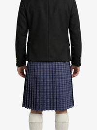 Person wearing a black jacket and blue plaid kilt on a white background