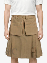 Person wearing a brown pleated skirt with large front pockets on a white background