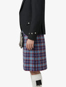 Person wearing a black jacket and blue plaid kilt on a white background