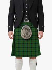 Person wearing a traditional Scottish kilt with a plaid pattern on a white background