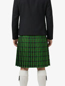 Person wearing a green plaid kilt with a black jacket on a white background
