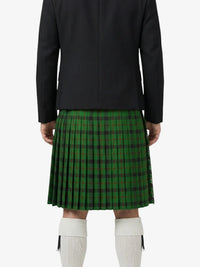 Person wearing a green plaid kilt with a black jacket on a white background