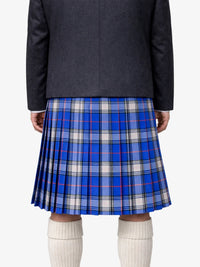 Person wearing a blue plaid kiltwith a dark blazer on a white background