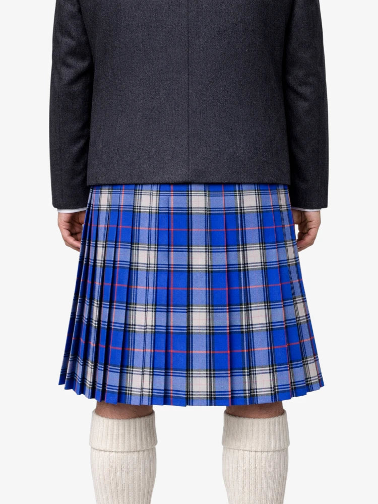 Person wearing a blue plaid kiltwith a dark blazer on a white background