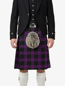 Person wearing a black jacket, purple plaid kilt, and white socks on a white background