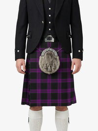 Person wearing a black jacket, purple plaid kilt, and white socks on a white background