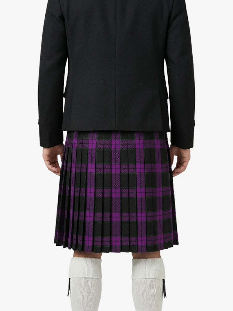 Person wearing a black jacket and purple plaid kilt on a white background