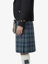 Person wearing a black jacket and plaid kilt on a white background