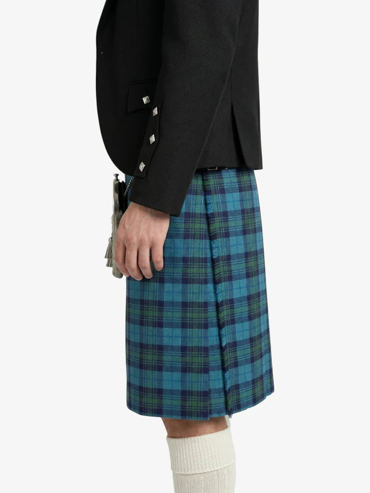Person wearing a black jacket and blue plaid kilt on a white background