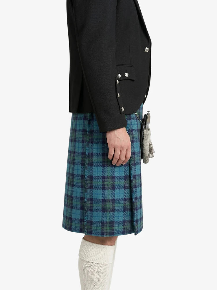 Person wearing a black jacket and blue plaid kilt on a white background