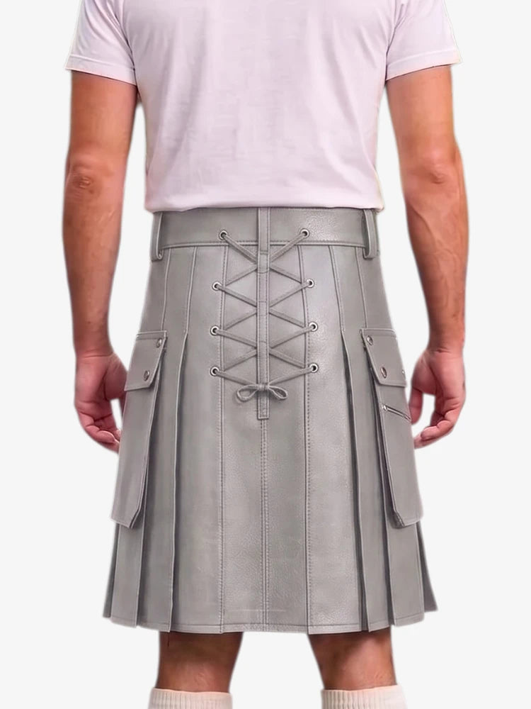 A person shown from the back wearing a light gray pleated faux-leather kilt with a lace-up back closure, side flap pockets, and a matching belt, paired with a pale pink t-shirt.
