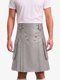 A person wearing a light gray faux-leather kilt with silver-tone metal snap details and side cargo pockets, paired with a white t-shirt against a plain white background.