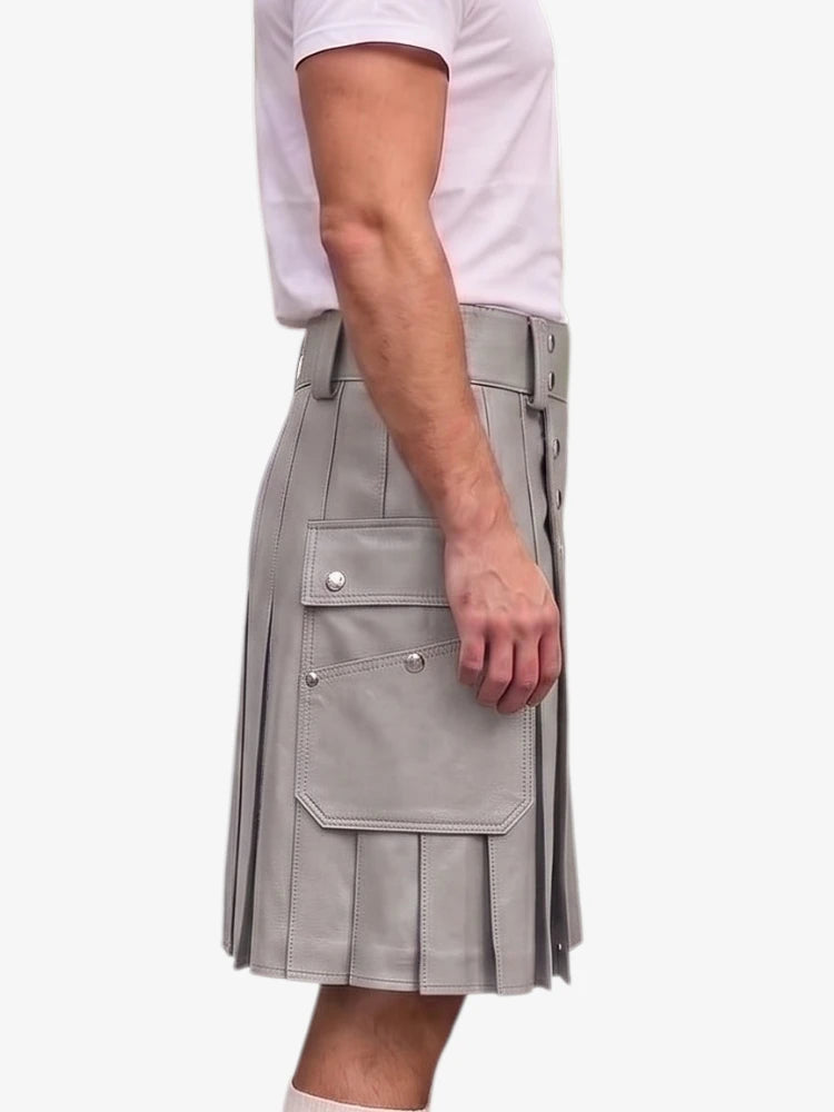 A person wearing a light gray pleated kilt-style skirt with flap cargo pockets and a white short-sleeve top, shown against a plain light background.