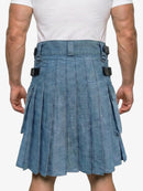 Person wearing a blue denim kilt on a white background
